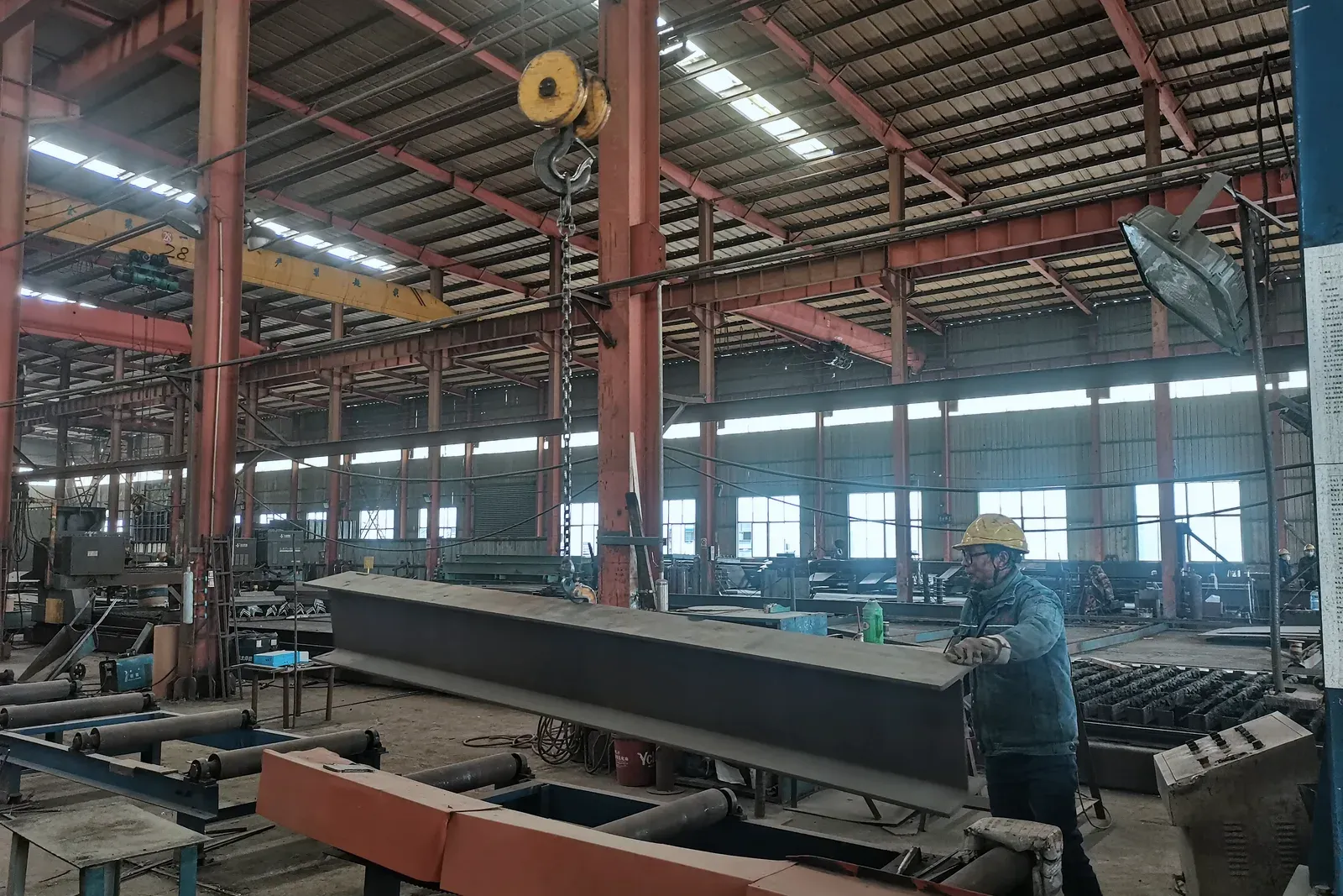 On the shop floor. An overhead crane moves a welded girder through our main bay.