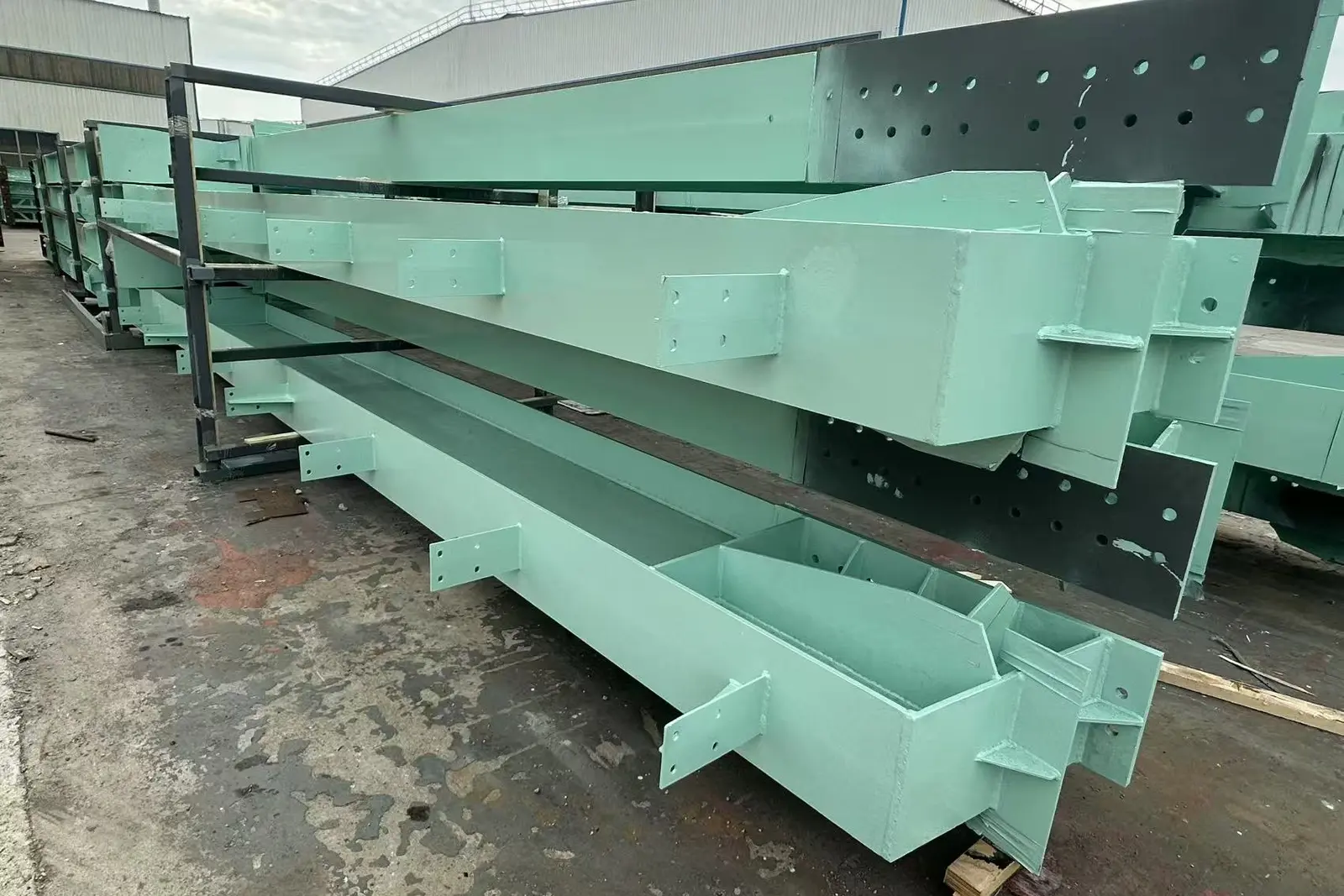 Painted columns and girders for the Indonesian smelter laid out in the yard before packing